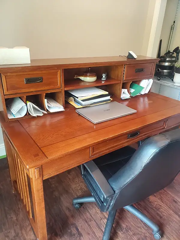 The same desk polished to a glossy, even finish with the floor below cleared