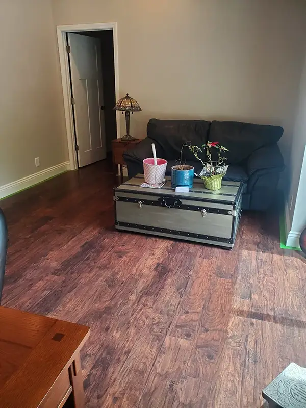 The same living room with gleaming floors and furniture set back in place