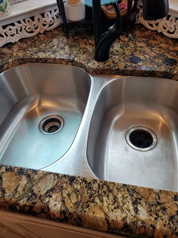The same sink clean and shining, drains and basins spotless