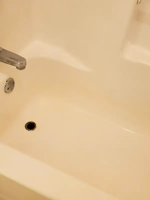 The same bathtub with a clean, bright basin and a clear drain